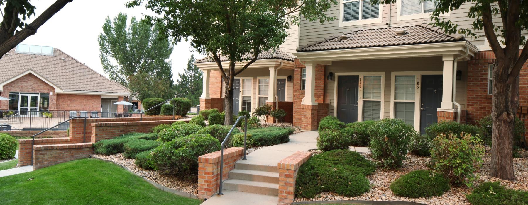 a house with a walkway and trees