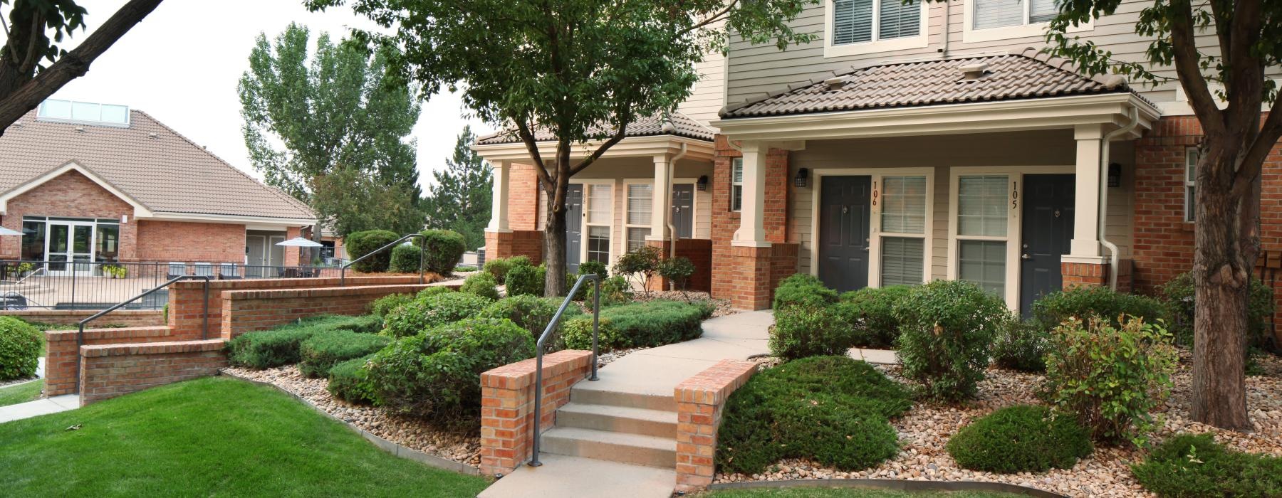 a house with a walkway and trees